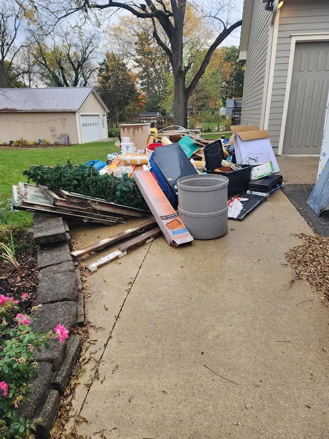 Dumpster being loaded with debris for Roofing Dumpster Rental in Chartiers